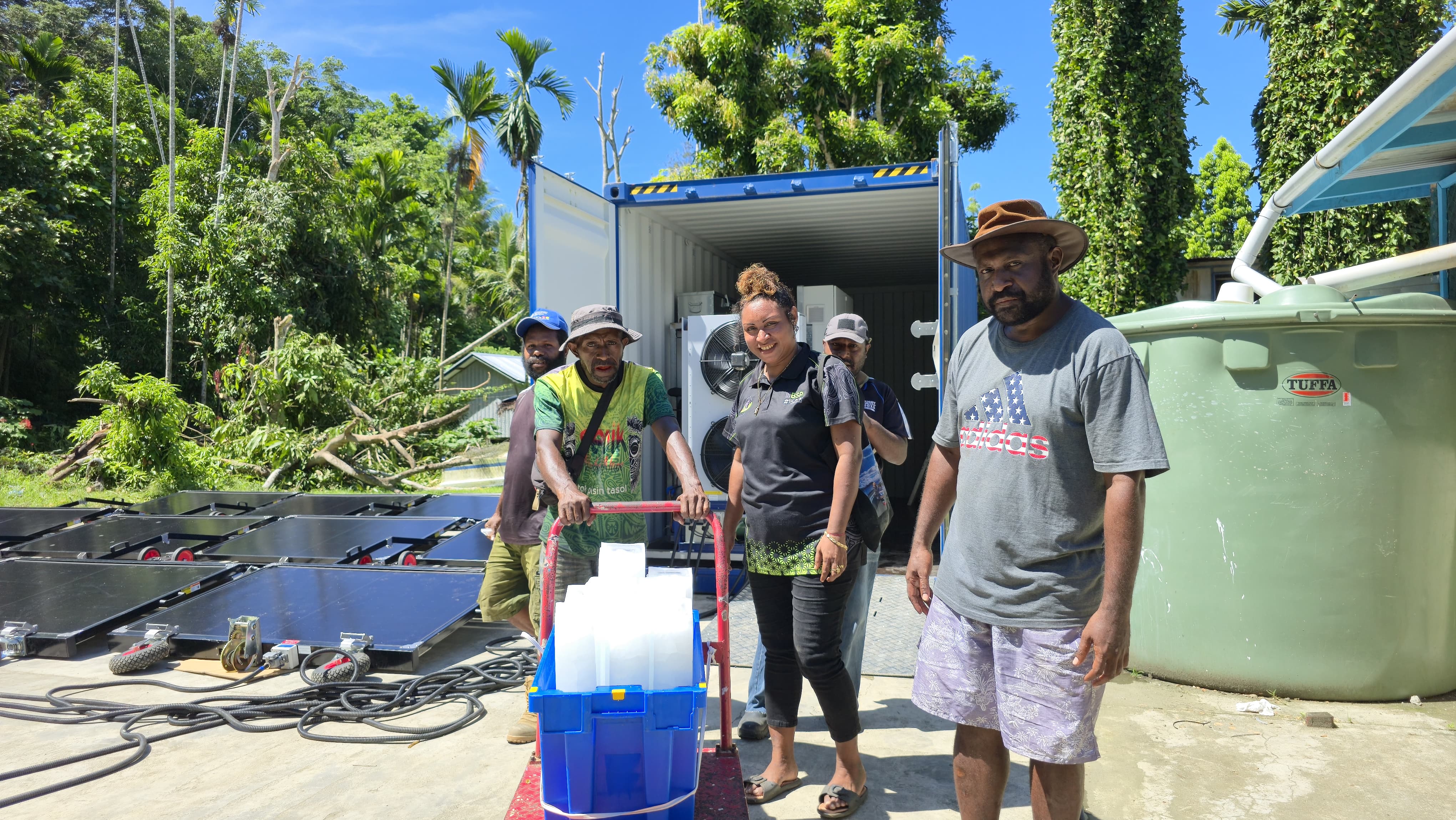 Satisfied fishers showing off ice block harvested from Solarator